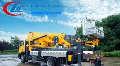 Sinotruk HOWO 45-50 meter aerial work platform truck in urban setting with extended arm and work basket at height