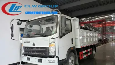 Rear view of the HOWO tipper truck with the dump box in mid-lift position and hydraulic pistons visible