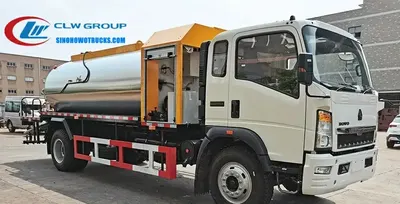 Cab view of the HOWO asphalt distributor showing control panel and spray rate display