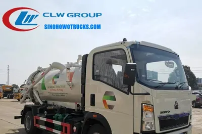 Side view of the HOWO sewage truck showing the fully open tailgate and hydraulic lift system