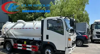 Side view of the HOWO sewage tanker showing the tank, pump, and access doors