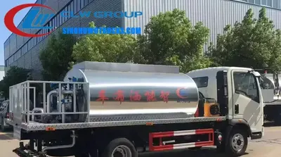 Sinotruk HOWO 5000 litre asphalt distributor truck in standard red with computer control panel and spray nozzles visible