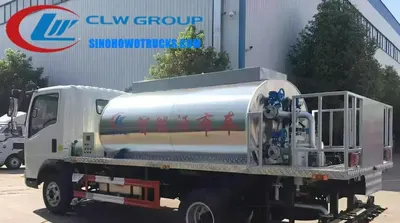 Rear view of the HOWO asphalt truck showing the 5000 litre tank, burner, and control platform