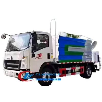 Rear high cannon mounted on the HOWO dust control truck spraying water over a dry road