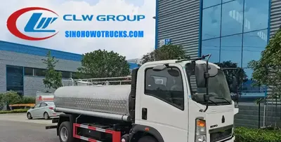 Side view of the HOWO water tanker showing stainless steel tank and spray system