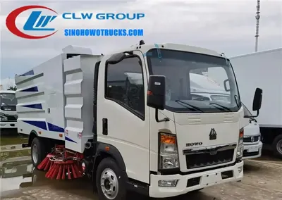 Side view of the HOWO street sweeper showing stainless steel dust tank and water tank