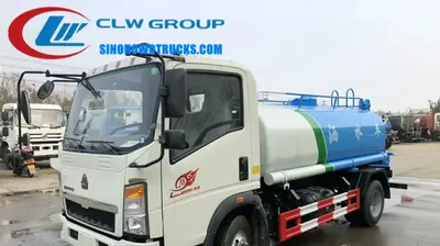 Sinotruk HOWO 4x2 mini water tanker truck with 5000 L tank and rear spray nozzles in urban setting