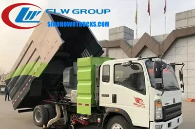Side view of the HOWO road sweeper showing stainless steel garbage tank and side discharge chute