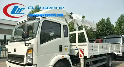 Sinotruk HOWO 6.3 ton crane lorry in construction site with telescopic boom extended and cargo box loaded