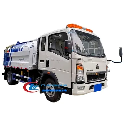 Front view of the HOWO jet vac truck with open rear door and hydraulic lift mechanism in operation