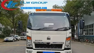 Sinotruk HOWO 6 ton jet vac truck with 5 cbm tank in service in Vietnam, rear view showing hydraulic lift and suction pipe