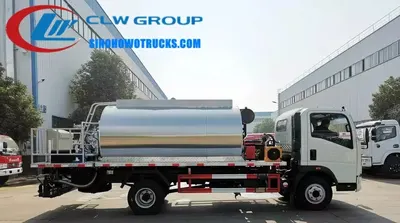 Side view of the HOWO asphalt spreader with adjustable spray width and cab-mounted control panel
