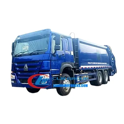 Rear view of the compactor truck with the push plate and hydraulic cylinder visible during compaction cycle