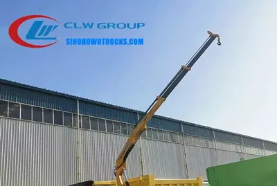 Rear view of the HOWO truck with crane, cargo box in tipping position and crane in stowed mode