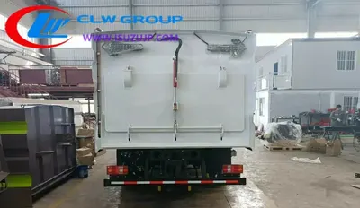 Side view of the HOWO sweeper showing stainless steel garbage tank and rear vacuum cleaner