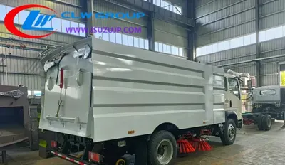 Rear view of the HOWO road sweeper with vacuum blower and water spray bar mounted on the chassis