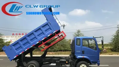Rear view of the HOWO dumper truck with the dump box raised and the hydraulic system visible