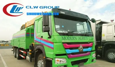 Side view of the HOWO crane truck with 360 degree slewing crane and water tank integrated into cargo box