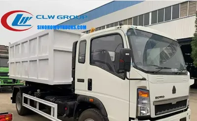 Rear view of the hook arm system with hydraulic cylinders and pull rod engaged with a 6 CBM container