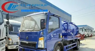 Side view of the HOWO sewage truck showing the full opening tailgate and hydraulic lift mechanism
