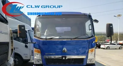 Rear view of the HOWO vacuum truck with the suction pipe and discharge nozzle in position