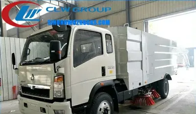 Side view of the HOWO sweeper with open brush housing and water spray bar visible