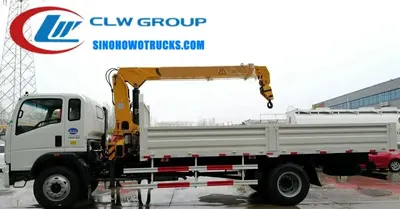 Side view of the HOWO crane truck showing the 360-degree slewing mechanism and cab