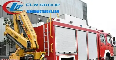 Side view of the HOWO fire utility truck showing the 5 ton crane and equipment lockers