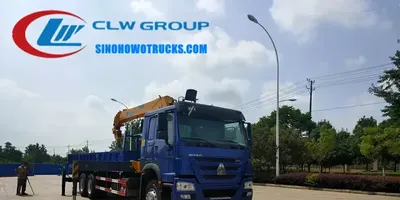 Rear view of the HOWO crane truck with the boom extended and the control panel visible