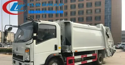 Sinotruk HOWO small garbage truck in urban waste collection with rear loading door open