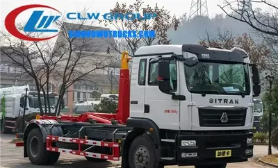 Side view of the SINOTRUK SITRAK roll off truck with a 15 m³ sealed container attached