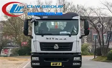 SINOTRUK SITRAK single axle roll off truck in urban waste collection setting with container being lifted