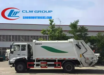 Side view of the Sinotruk Steyr compactor truck showing hydraulic cylinders and loading ladle in the front bunker