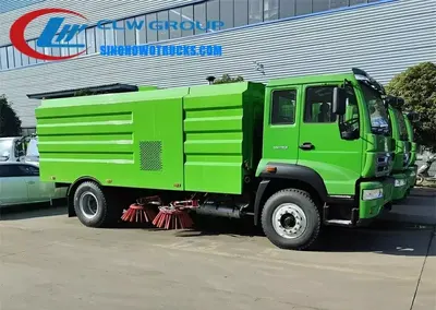 Sinotruk HOWO 8 ton street sweeper truck in urban setting with sweeping brushes in operation