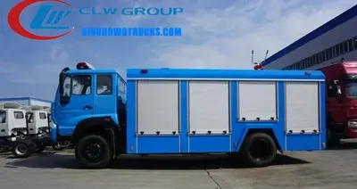 Side view of the fire truck with open equipment lockers and hose tables