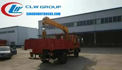 Front view of the truck with left hand drive cabin, air conditioning, and integrated crane system