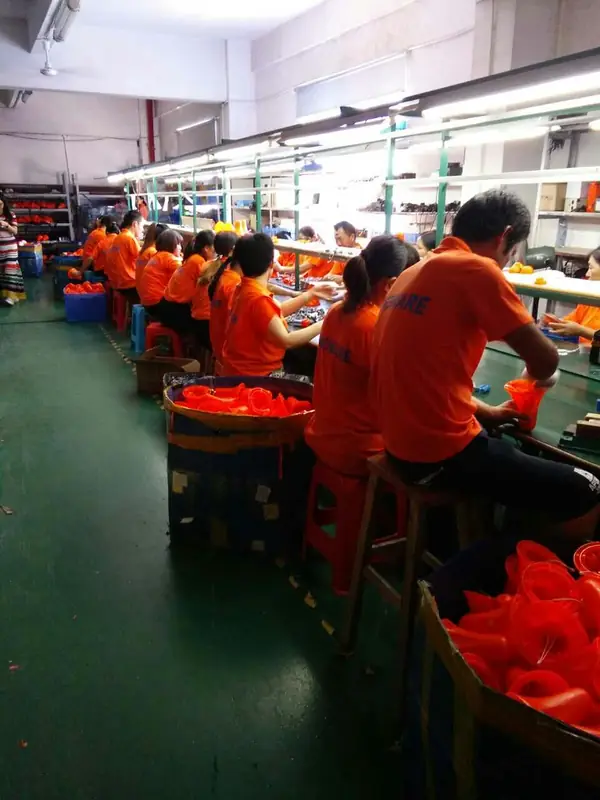 Assembly team fitting and testing solar lanterns at the Shenzhen workshop.