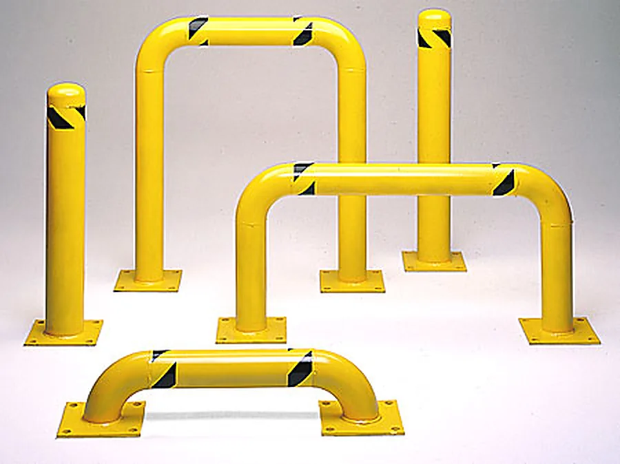 Yellow steel pipe safety bollards of several heights grouped on a white background