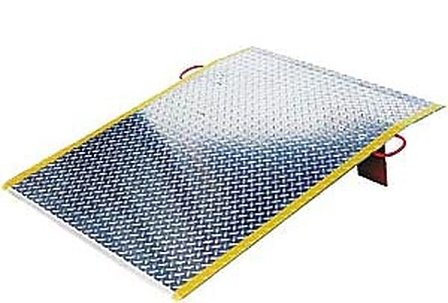 Aluminium dock board with yellow safety curbs and lifting loops at the leading edge