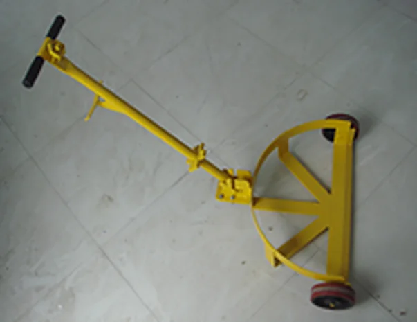 Yellow steel drum caddy with pull handle photographed on the workshop floor