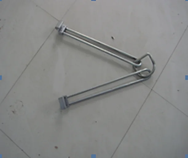 Bare steel drum clutcher arms with pivot linkage on the workshop floor