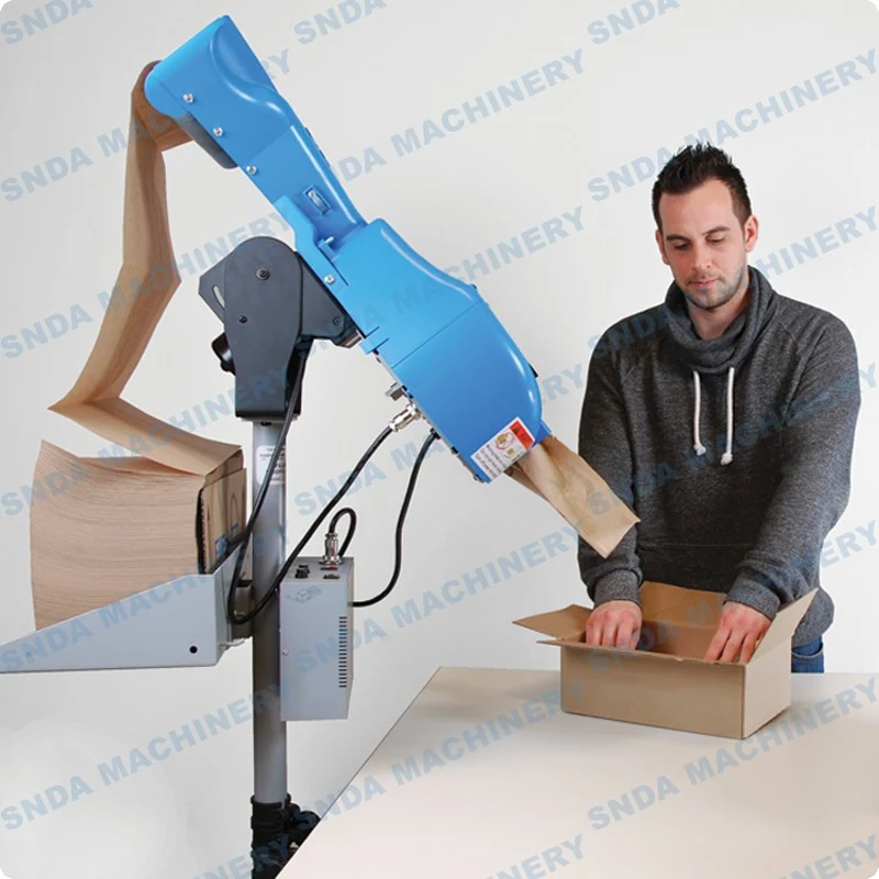 Machine in operation with kraft paper being fed through the perforation and folding section