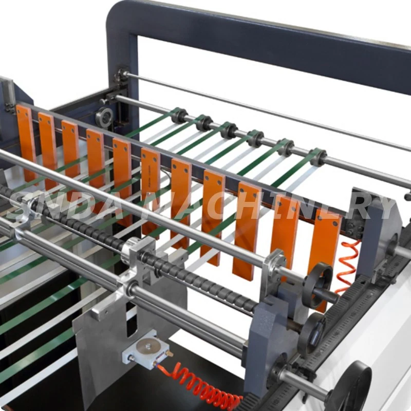 Close-up of the cutting mechanism and sheet stacking area on the paper sheeter