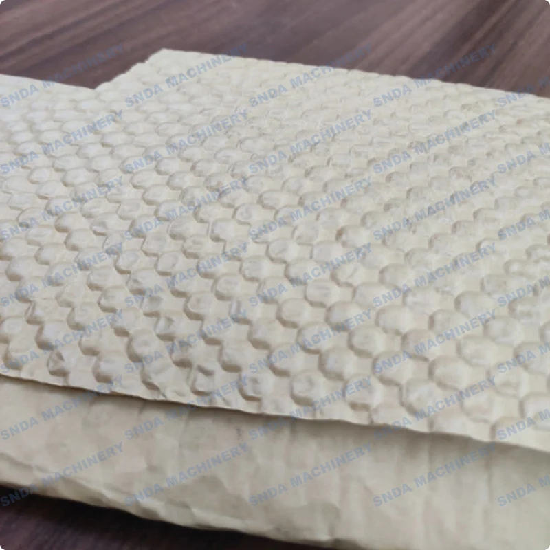Inline laminating station applying flat paper to the back of embossed kraft paper