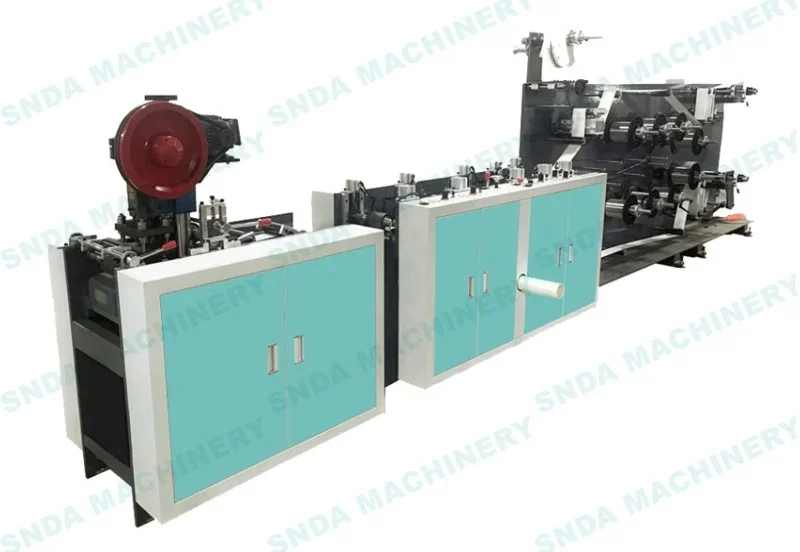 Industrial bag making machine with teal cabinets and black mechanical rollers on a white background