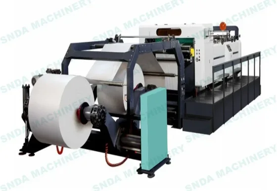 Industrial paper roll converting machine with large white paper rolls, teal and gray body, on white background