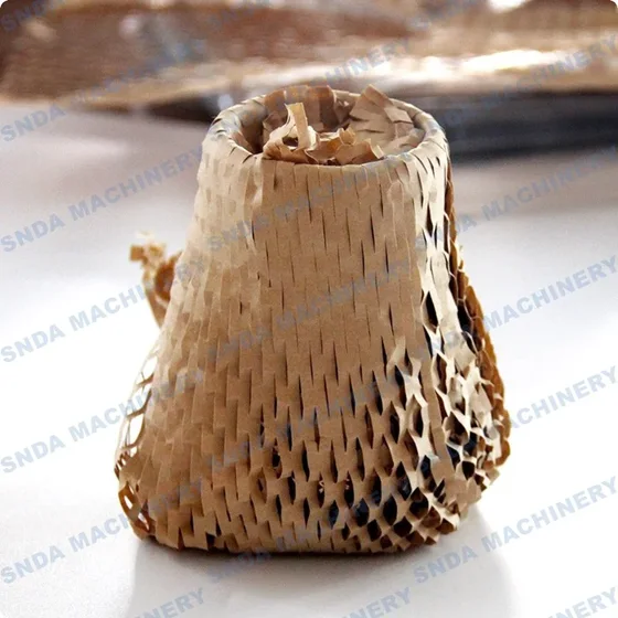 Cup-shaped sample formed from kraft honeycomb paper cushioning wrap sitting on a white surface