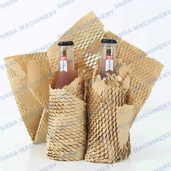 Two capped glass bottles wrapped in kraft honeycomb paper protective packaging on a white background