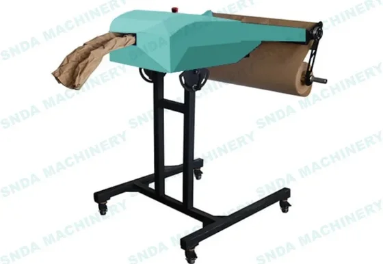 Teal paper cushioning machine on a wheeled black stand dispensing crumpled kraft paper from a roll