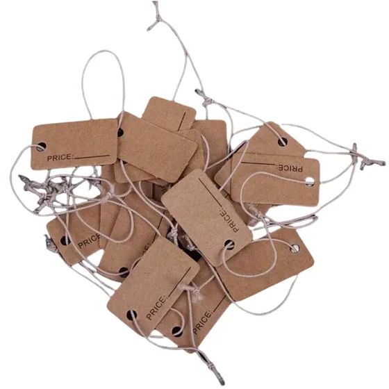 Pile of brown kraft paper price tags printed with 'PRICE' and attached strings on a white background
